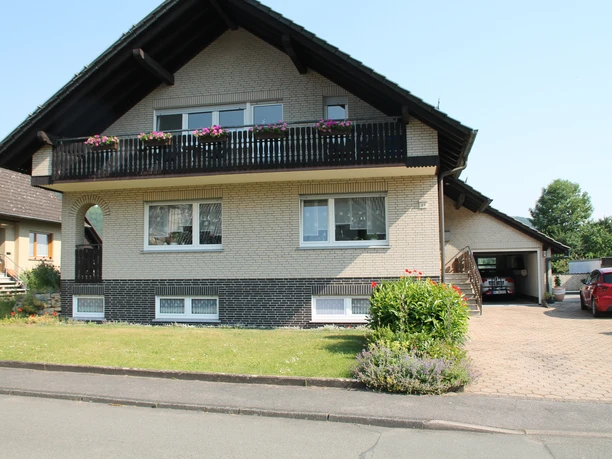 Exterior view of the residential building with the apartment in the basement