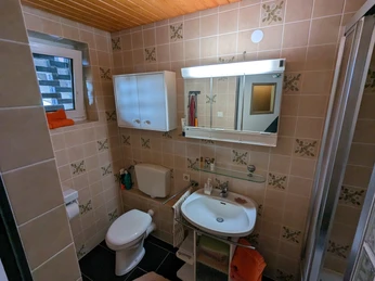 beige tiled bathroom with WC and washbasin