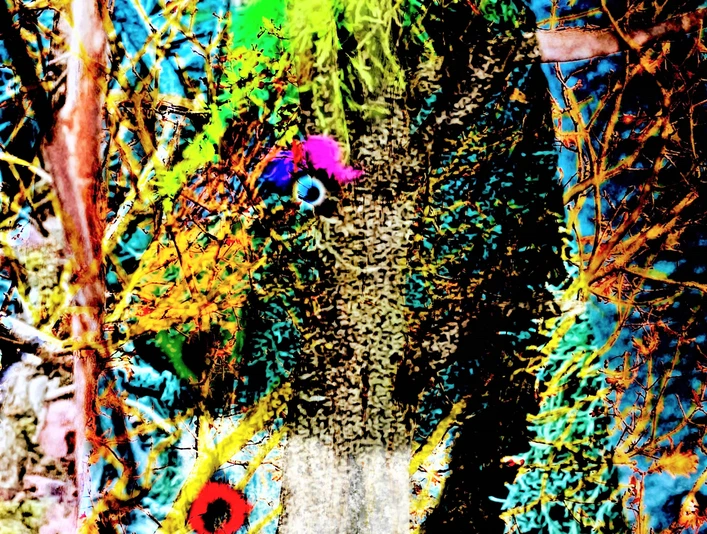 Er hatte sich gut versteckt - Kopie.jpg Ein Baumstamm, mit leuchtend grüner Farbe und bunten Elementen dekoriert, versteckt sich im dichten Gestrüpp.