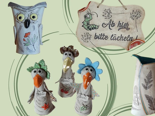 Ceramic figures in the shape of animals, including an owl and three birds with colorful details, as well as a sign with the inscription "From here, please smile!".