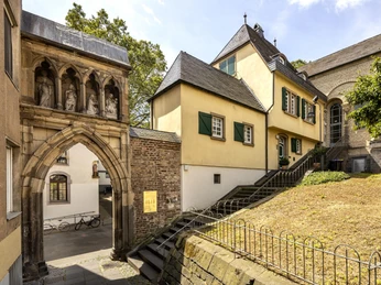 St. Mary in the Capitol Die romanische Kirche Sankt Maria im Kapitol in Köln zeigt ihren historischen Eingang und die angrenzende Architektur.The Romanesque church of St. Maria im Kapitol in Cologne shows its historic entrance and the adjoining architecture.
