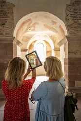 Female couple looking at the former ornate decorations in St. John's Choir on a tablet