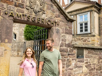 Pärchen verlässt Amtsgericht durch altes steinernes TorCouple leaves district court through old stone gate