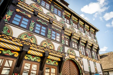 Elaborately designed half-timbered façade, richly decorated with carvings and colorful paint