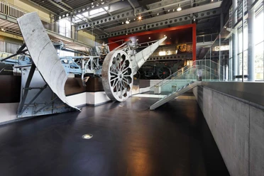Emsland Moormuseum Großes historisches Moorfahrzeug mit Metallrädern in moderner Museumshalle mit Glas und Stahl.