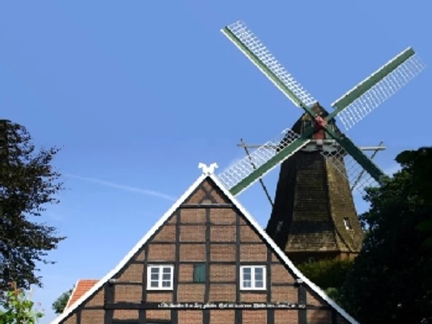 Mersmühle (mit Mühlenmuseum Haren) Historische Windmühle mit Fachwerkhaus und gepflegtem Garten unter klarem blauen Himmel