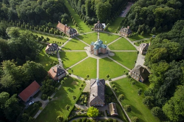 Schloss-clemenswerth Luftaufnahme von Schloss Clemenswerth mit achteckiger Anlage, Pavillons und symmetrischen Wegen im Grünen.