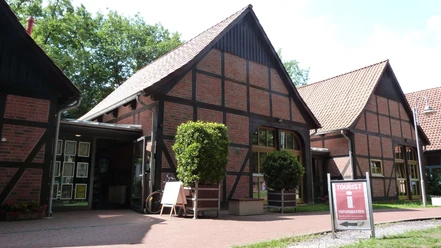 Half-timbered tourist information center in Steinhude: Inviting brick building with green surroundings.