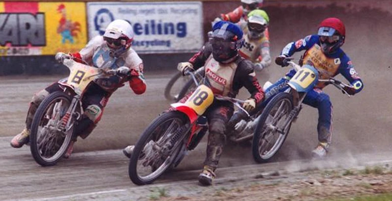 Spannende Motorrad-Sandbahnrennen im Emstalstadion des MSC Motorsportclubs Harsewinkel Drei Speedway-Fahrer in voller Schutzausrüstung rasen in einem engen Rennen auf einer Schotterstrecke.