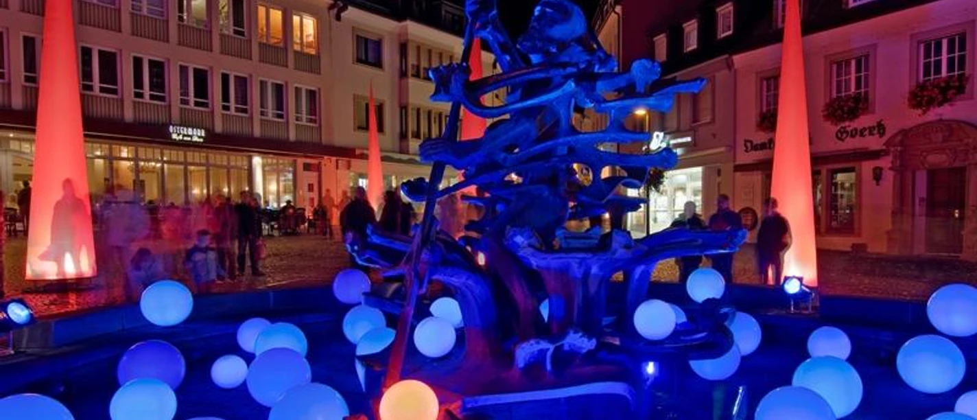 Neptunbrunnen Paderborn Leuchtende Kugeln umgeben den Neptunbrunnen in Paderborn bei Nacht, stimmungsvoll illuminiert.