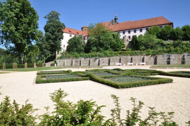 Knotengarten am Bad Iburger Schloß Gepflegter Knotengarten mit geometrischen Beeten, vor der historischen Kulisse des Bad Iburger Schlosses.