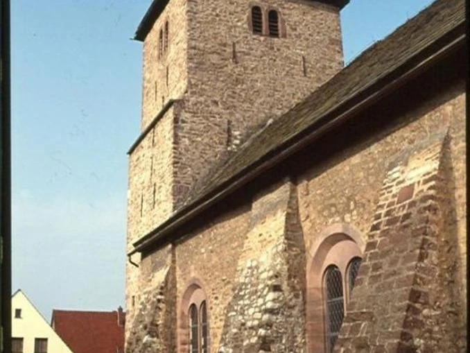 evangelische Kirche Steinbau der evangelischen Kirche mit massiven Stützpfeilern, Turm mit spitzem Dach im Zentrum.