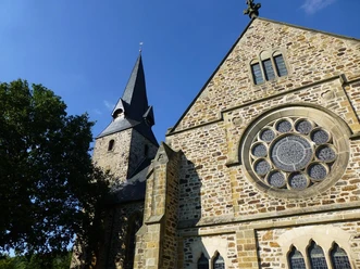 Bartholomäuskirche Romanische Kirche St. Bartholomäus mit markantem Glockenturm und beeindruckendem Rundfenster.