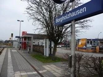 Bahnhof Borgholzhausen Bahnhof Borgholzhausen mit Gleisen, Wartehäuschen und Bahnhofsschild an einem bewölkten Tag.
