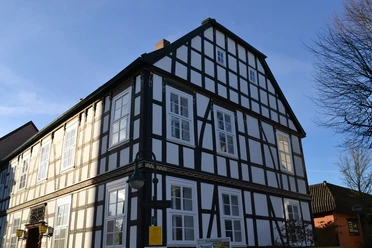 Fachwerkhaus in Bad Salzuflen, Nordrhein-Westfalen, bei Sonnenschein. Symmetrische Fassade mit weißen Wänden.