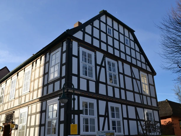 Fachwerkhaus in Bad Salzuflen, Nordrhein-Westfalen, bei Sonnenschein. Symmetrische Fassade mit weißen Wänden.