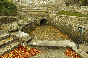 Nethequelle Neuenheerse Nethequelle in Neuenheerse: Historisches Quellbecken mit Herbstlaub, umgeben von Bruchsteinmauern.