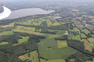 blick_nach-s-den-flugplatz-und-zwischenahner-meer Aufnahme aus der Luft zeigt das Zwischenahner Meer und den Flugplatz, umgeben von grünen Feldern und Wäldern.