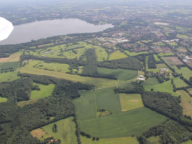 blick_nach-s-den-flugplatz-und-zwischenahner-meer Aufnahme aus der Luft zeigt das Zwischenahner Meer und den Flugplatz, umgeben von grünen Feldern und Wäldern.