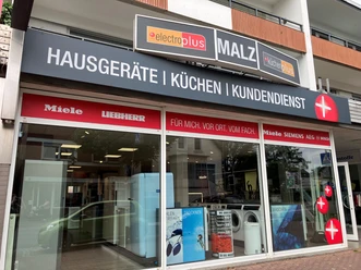 Fassade von Malz Hausgeräte Service mit großen Schaufenstern und Markenlogos