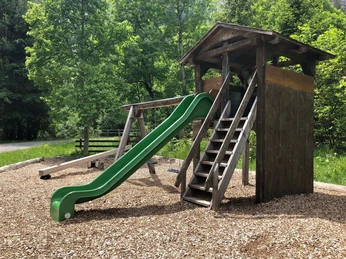Playground with slide, swing and seesaw
