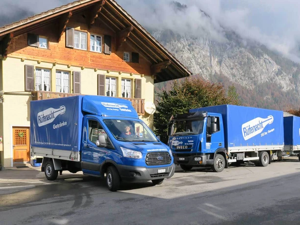 Blue lorries bearing the Rüfenacht drinks logo