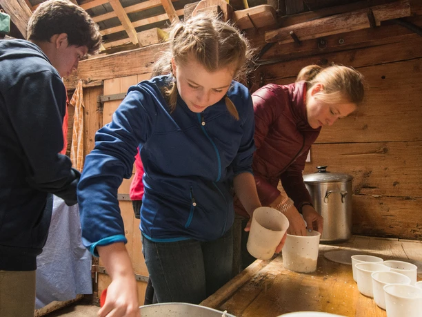 Motivated schoolgirls making cheese