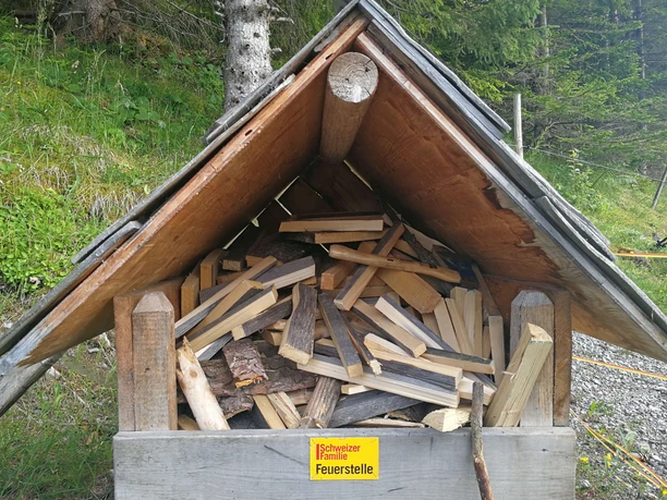 A covered wood store for a fire pit