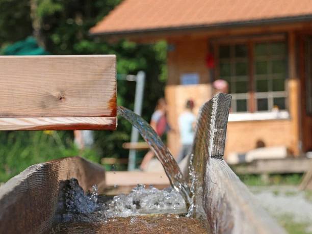 Running water in the jug system Water runs from one wooden jug into the other