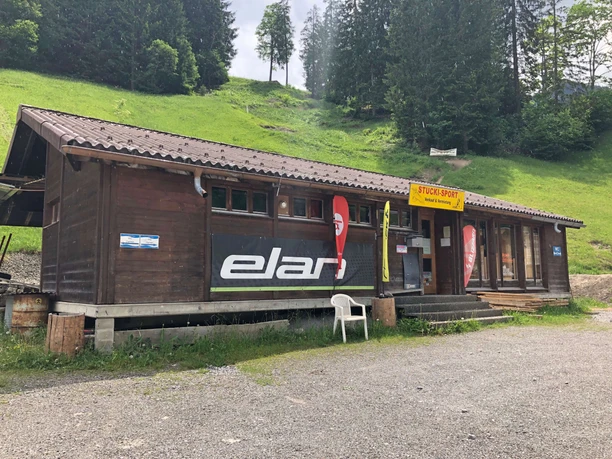 A brown, elongated wooden building