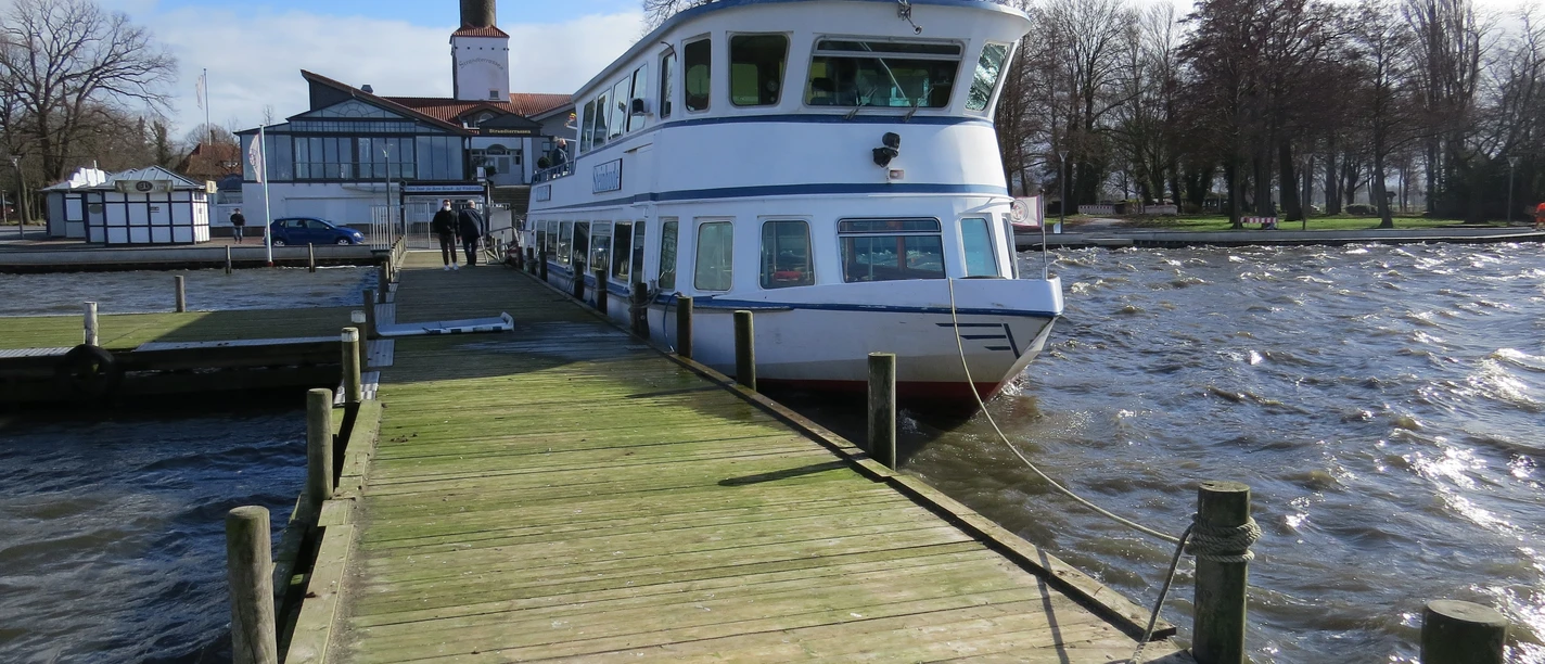 Anleger Steinhude A passenger ship is anchored on a wooden jetty in the windswept waters near Steinhude.