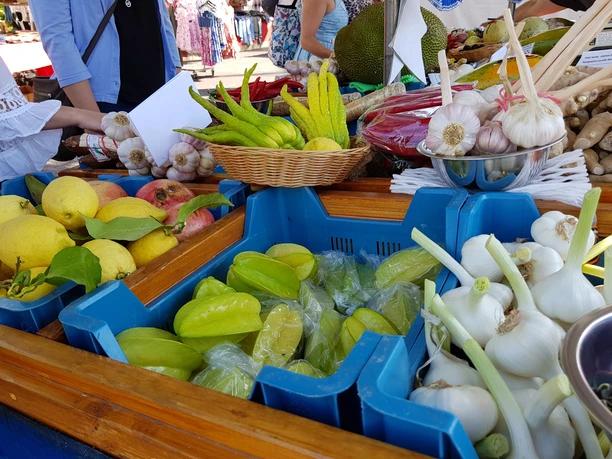 Gemüsestand auf dem Vieh- und Krammarkt Frische exotische Früchte und Gemüse auf einem bunten Marktstand ausgestellt.