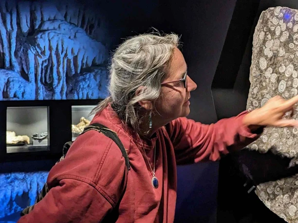 Besucherin an der Goniatitenwand Eingangsraum zu Höhle und archäologischem Museum HEZ Besucherin an der Goniatitenwand Eingangsraum zu Höhle und archäologischem Museum HEZ