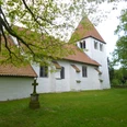 Kirche Heimsen Weiße Kirche mit rotem Ziegeldach in grüner, ruhiger Umgebung, von Bäumen umgeben.