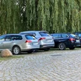 Parkplatz_Schlosswiese1_22082023_PetraRoemer.jpg Eine gepflasterte Straße führt zu den Parkmöglichkeiten. Im Hintergrund stehen Bäume