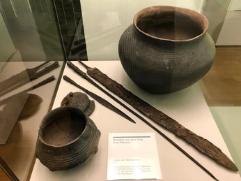 Altsachsengräber Liebenau - Ausstellungsstücke im Landesmuseum Hannover Eine Vitrine zeigt historische Werkzeuge und Keramikgefäße aus einem altsächsischen Männergrab.