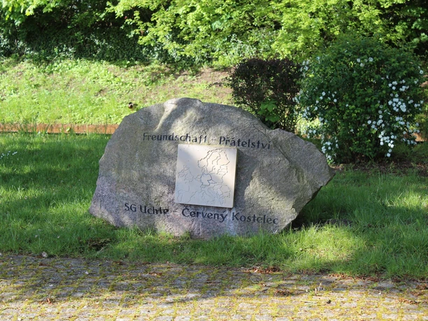 Gedenkstein mit Inschrift "Freundschaft - Přátelství" in einem grünen Park, hervorgehobene Karte.