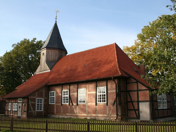 Die Corvinuskirche in Erichshagen ist ein Fachwerkbau mit rotem Ziegeldach und einem Kirchturm.