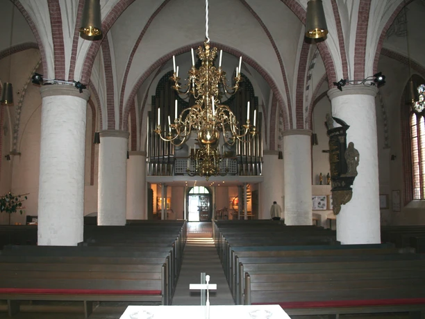 The interior of St. Martin's Church features an ornate chandelier and high vaulted ceilings.
