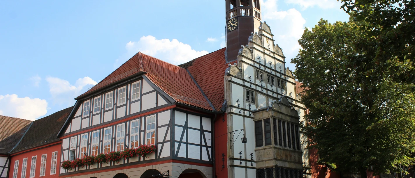 Rathaus Nienburg Historic Nienburg Town Hall with striking bell tower, half-timbered façade and colorful outdoor catering.
