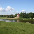 Schloss Petershagen Schloss Petershagen an der Weser, umgeben von grünen Wiesen und einem klaren blauen Himmel.