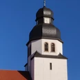 Kirchturm St Johannes_HRenerig .jpg Kirchturm der St. Johannes-Kirche mit markanter Zwiebelhaube vor klarem blauen Himmel.