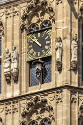 Platzjabbeck The monumental clock sits enthroned on the Cologne Town Hall tower, surrounded by detailed statues.