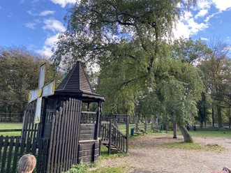 The dark wooden play equipment at the Russian log cabin blends in beautifully with the natural surroundings.