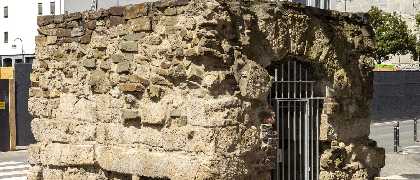 Roman sewer Old Roman sewer in Cologne, solid stone walls, modern buildings in the background.