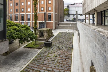Section of the Roman harbor road Roman harbor road in Cologne, paved path between modern buildings