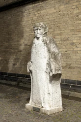 Johann Adam Schall von Bell sculpture The sculpture shows Johann Adam Schall von Bell, made of light-colored stone, with striking facial features and an imposing robe, standing in front of a wall.