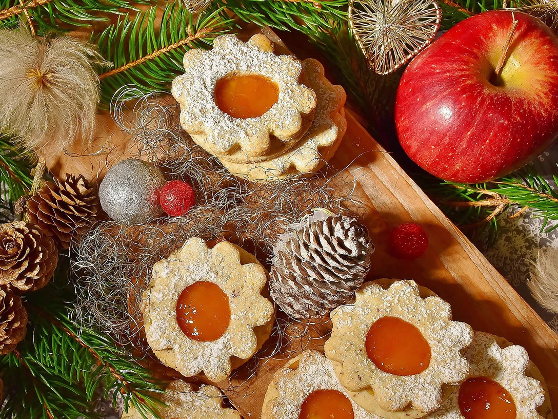 weihnachtsstube-plaetzchen-kekse-advent.jpg Weihnachtsplätzchen auf Holztablett mit Tannenzweigen.