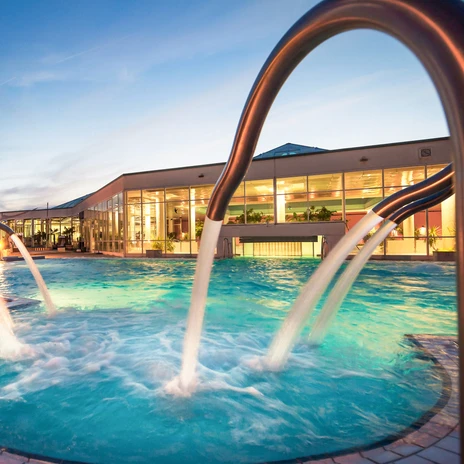 L'espace extérieur du HEIDE SPA à Bad Düben avec piscine s'illumine au crépuscule, bien-être, excursion, famille, loisirs