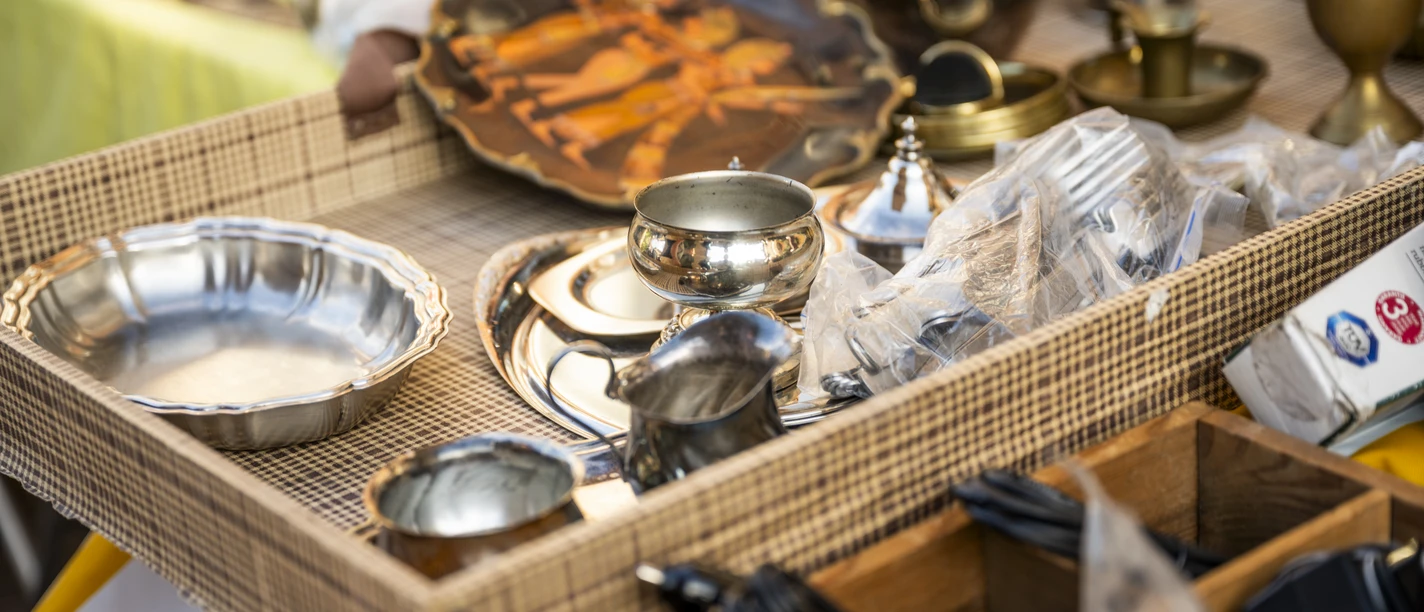 Flohmarkt.jpg Verkaufsstand mit altem Silberbesteck, Krügen und Tellern auf einem Flohmarkt in Meppen.